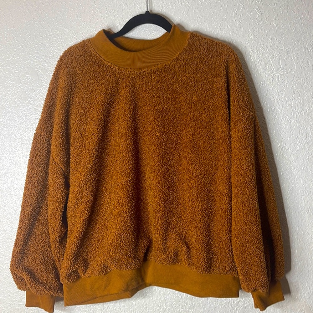 A soft and cozy sweater. It is made from a brand called “ Fashion.”